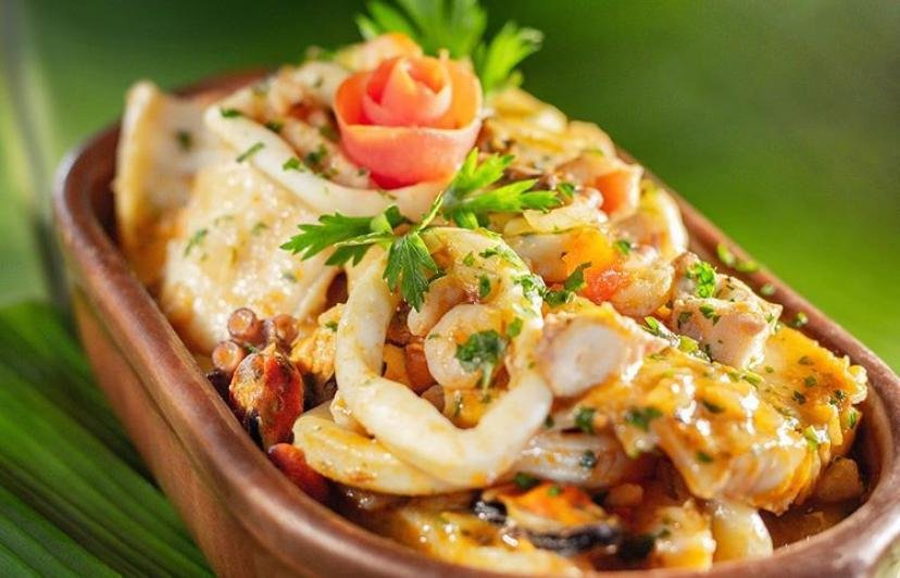 Moqueca caiçara borbulhando na panela de barro